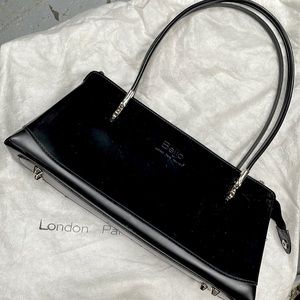 A brand new Beijo black handbag/purse. With original cover and warranty book.